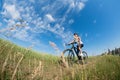 Mountain biking happy sportive girl relax in meadows sunny countryside Royalty Free Stock Photo