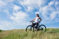 Mountain biking happy sportive girl relax in meadows sunny countryside Royalty Free Stock Photo