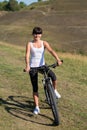 Mountain biking happy sportive girl relax in meadows sunny countryside Royalty Free Stock Photo