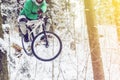 Mountain biking in snowy forest