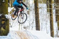 Mountain biking in snowy forest Royalty Free Stock Photo