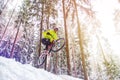 Mountain biking in snowy forest Royalty Free Stock Photo