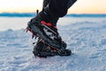 Mountain Boot with crampons on while hiking in the mountains in winter.