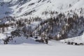 Mountain cabins covered with snow in Simplon Pass on a sunny winter day, Switzerland