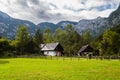 Mountain cabins in the region of Ukanc near the Lake Bohinj in the Triglav National Park in Slovenia on summer day with clouds Royalty Free Stock Photo