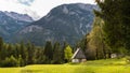 Mountain cabins in the region of Ukanc near the Lake Bohinj in the Triglav National Park in Slovenia on summer day with clouds Royalty Free Stock Photo