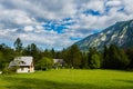 Mountain cabins in the region of Ukanc near the Lake Bohinj in the Triglav National Park in Slovenia on summer day with clouds Royalty Free Stock Photo