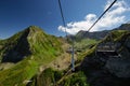 Mountain cableway stretching down over beautiful early autumn mountain landscape. Royalty Free Stock Photo