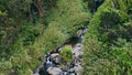 Mountain cascades flowing rocks drone view. Serene running creek at mossy cliffs Royalty Free Stock Photo