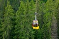 Mountain chairlift on the background of green pine forest Royalty Free Stock Photo