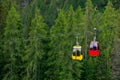 Mountain chairlift on the background of green pine forest Royalty Free Stock Photo