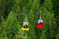 Mountain chairlift on the background of green pine forest Royalty Free Stock Photo