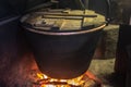 Mountain cheese processing, boiling the milk through a large pot on a wood fire, where the renduum will be added later
