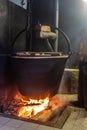 Mountain cheese processing, boiling the milk through a large pot on a wood fire, where the renduum will be added later