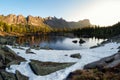 Mountain clear glacier lake among large rocks and cedar forest Royalty Free Stock Photo