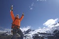 Mountain Climber With Arms Raised Against Snowy Mountains Royalty Free Stock Photo