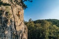 Mountain climber climbing the cliff using his climbing equipment