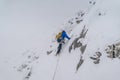 Mountain climber climbing the snow covered Alps in Mont Blanc Massif
