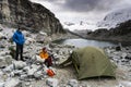 Male and female mountain climber at a high camp in the Andes in Peru with a tent and lake in the foreground