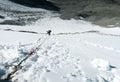 Mountain climber going down the vertical wall. Climbing equipment. Snowy mountain pass Royalty Free Stock Photo