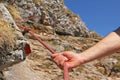 Mountain climber holding on a climbing rope