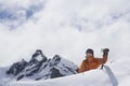 Mountain Climber Reaching Over Snowy Peak