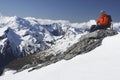 Mountain Climber Using Laptop On Mountain Peak