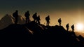 mountain climbers\' silhouettes stand as a testament to importance of working together towards a goal Royalty Free Stock Photo