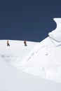 Mountain Climbers Walking Past Ice Formation Royalty Free Stock Photo