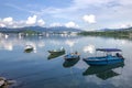 Mountain, cloudscape, fishing boats and yacht on lake Royalty Free Stock Photo