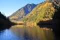 Mountain with colourful streak (reflection) on a lake