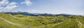 Mountain cottage hut or house on hill Velika Planina alpine meadow landscape. Eco farming. Kamnik Alps, Slovenia. Big Plateau. Pan Royalty Free Stock Photo