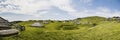 Mountain cottage hut or house on hill Velika Planina alpine meadow landscape. Eco farming. Kamnik Alps, Slovenia. Big Plateau. Pan Royalty Free Stock Photo