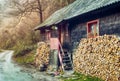 Mountain cottage of wood with pile of firewood