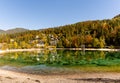 Mountain cottages and holiday homes on the shores of Lake Jasna in beautiful autumn colors forest in northern Slovenia