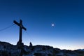 Mountain cross on peak with moon Royalty Free Stock Photo