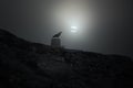 Mountain crow in an overcast full moon night