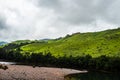 Mountain with dry river flow and green forests