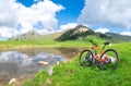 Mountain ebike stops near an alpine lake in spring