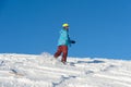 MOUNTAIN ELBRUS, RUSSIA - NOVEMBER 30, 2017: A snowboard girl wearing a sun mask and a scarf is riding down the alpine