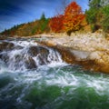 Mountain fast flowing river stream of water in the rocks at autumn Royalty Free Stock Photo