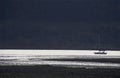 Night time. Sailing boat on lake. Silver reflections Royalty Free Stock Photo