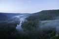 Mountain forest landscape. Trees and the river in the fog in the early morning. Royalty Free Stock Photo