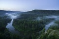 Mountain forest landscape. Trees and the river in the fog in the early morning. Royalty Free Stock Photo