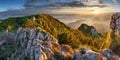 Mountain forest landscape under evening sky with clouds in sunlight. Royalty Free Stock Photo