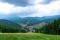 Mountain forest landscape under evening sky with clouds in sunlight. Royalty Free Stock Photo