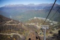 Mountain funicular through autumn forest on backdrop of Caucasus mountains to observation deck tops 2320 m. A clear