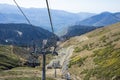 Mountain funicular through autumn forest on backdrop of Caucasus mountains to observation deck tops 2320 m. A clear