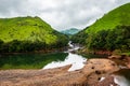 Mountain gap with river flowing and green forests