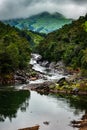 Mountain gap with river flowing and green forests